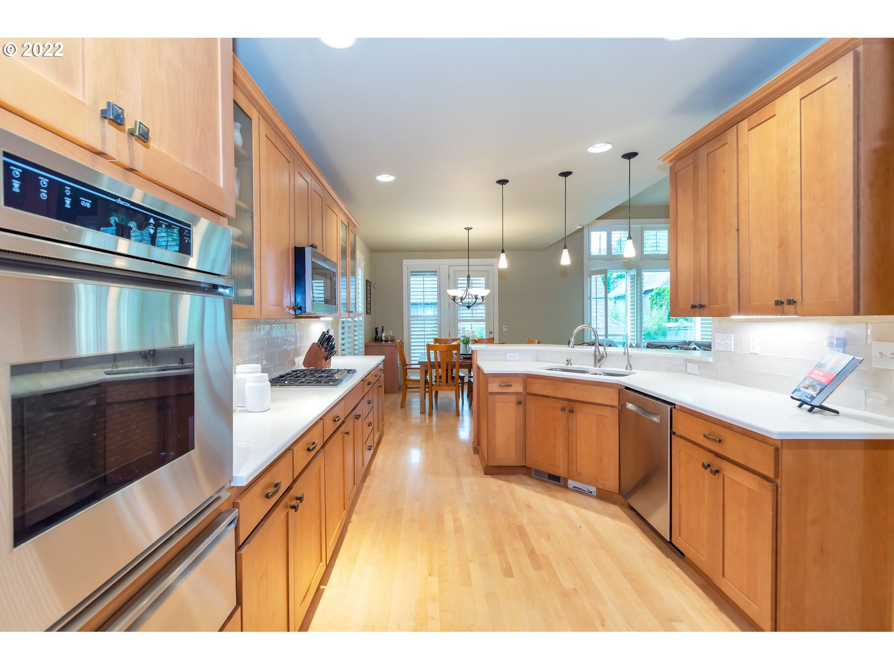 19704 Southeast 26th Way Camas, WA 98607 - Photo 13 of 32 a large kitchen with stainless steel appliances kitchen island granite countertop a large kitchen counter top a stove and a sink