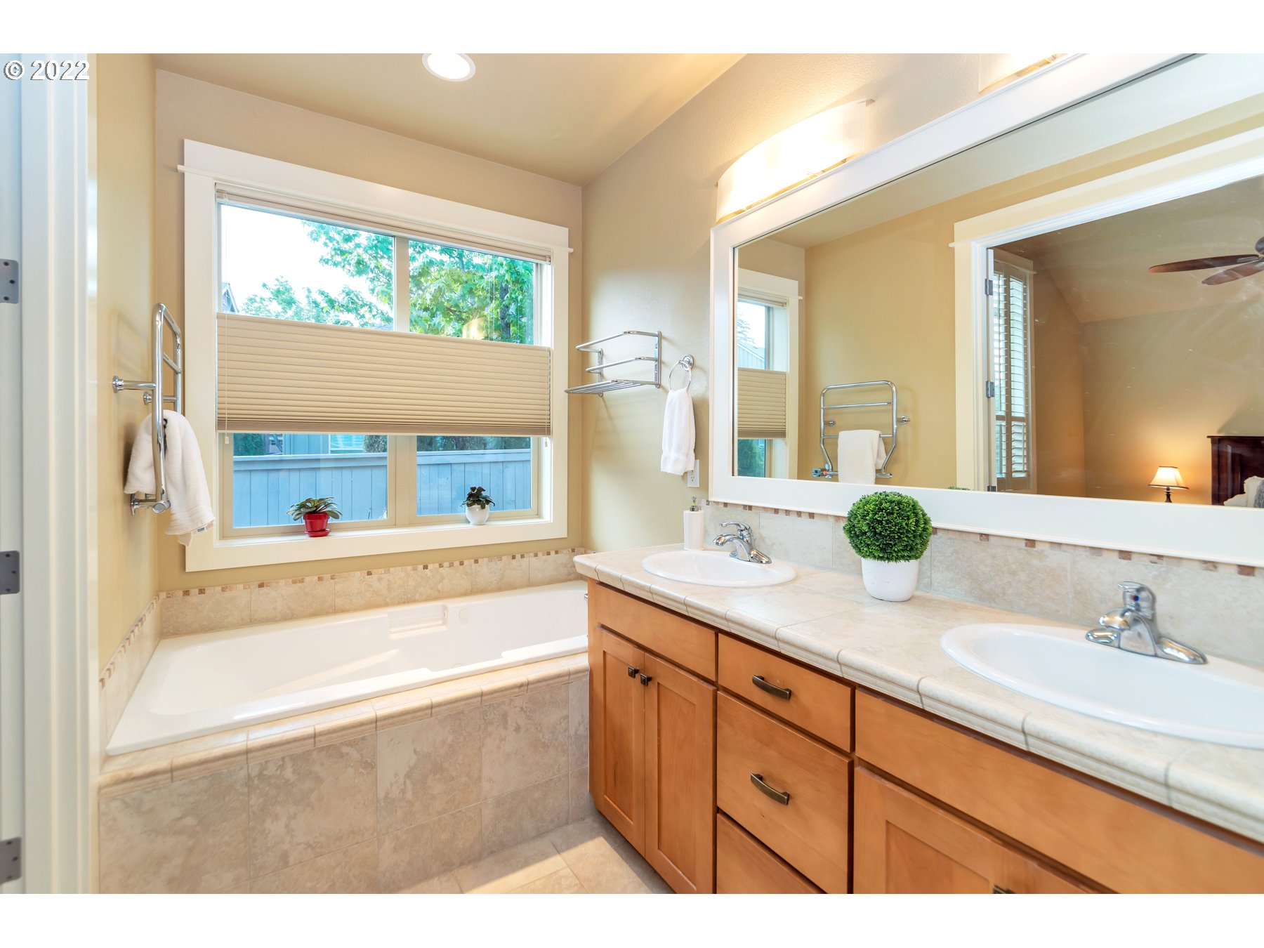 19704 Southeast 26th Way Camas, WA 98607 - Photo 23 of 32 a bathroom with a granite countertop sink mirror and a bathtub