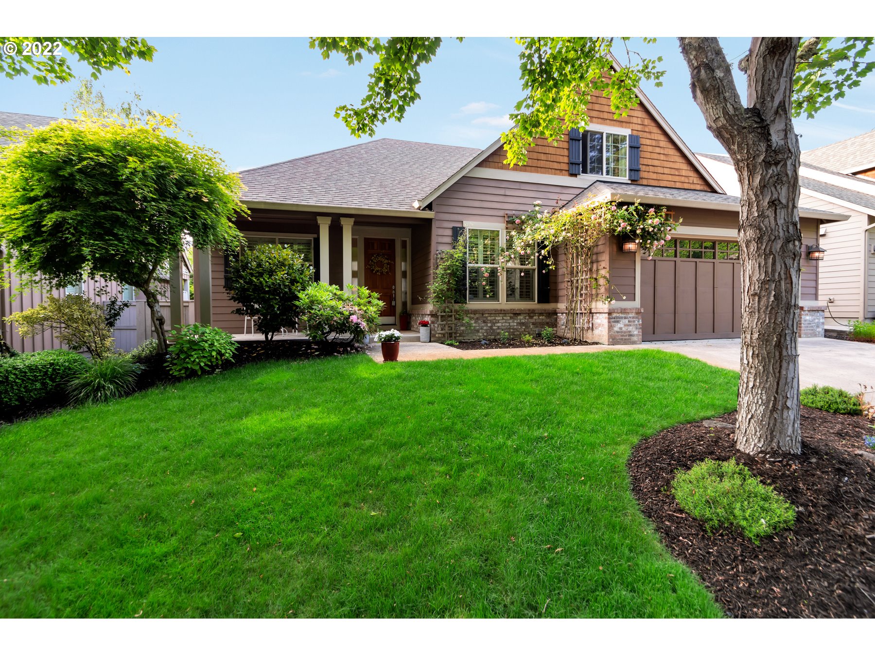 19704 Southeast 26th Way Camas, WA 98607 - Photo 4 of 32 a front view of a house with a garden and porch