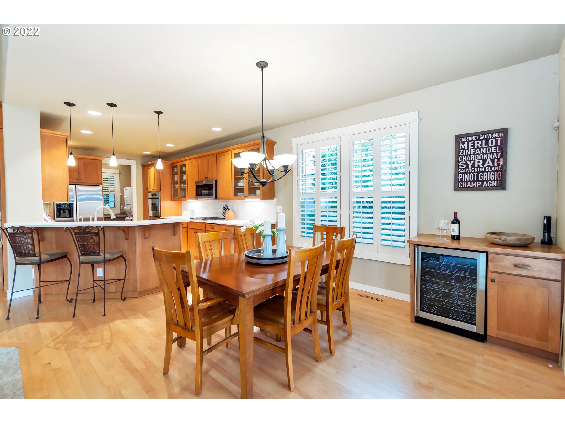 19704 Southeast 26th Way Camas, WA 98607 - Photo 10 of 32 a dining hall with stainless steel appliances kitchen island granite countertop a table chairs and a view of living room