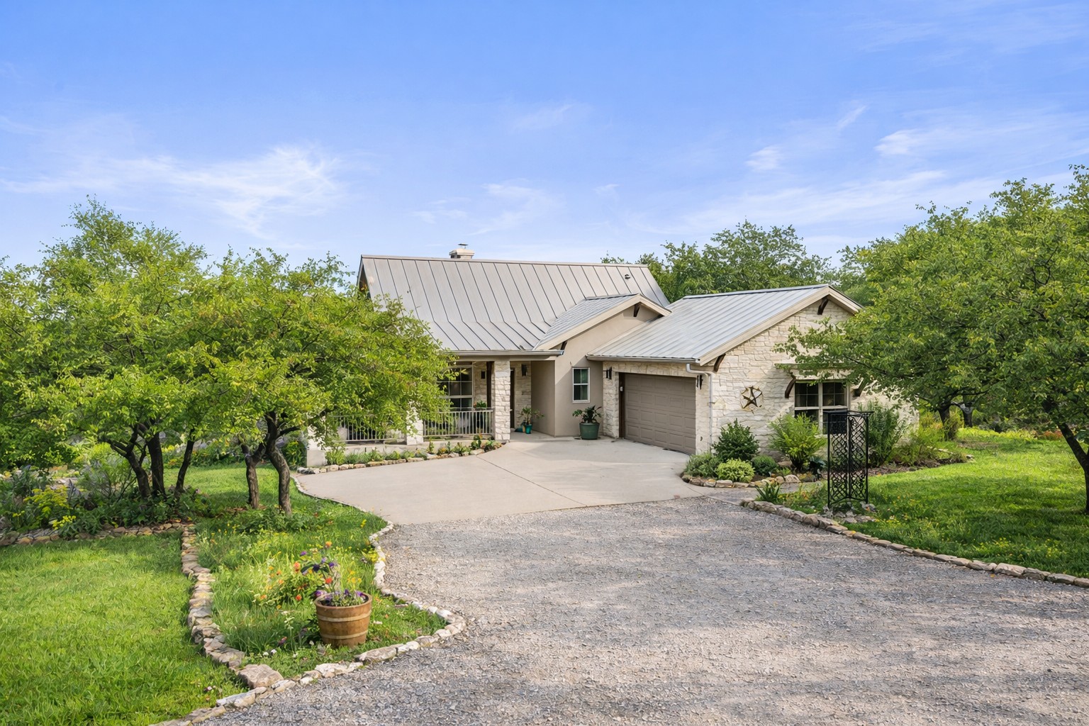 232 Crooked Oak Round Mountain, TX 78663 - Photo 30 of 40 Single story home featuring driveway, stone siding, a front lawn, and an attached garage