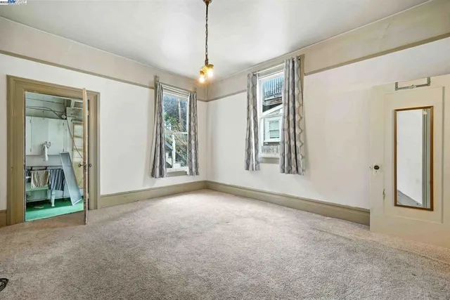 an empty room that has a large window