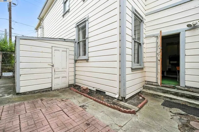 a view of a house with backyard and wooden fence