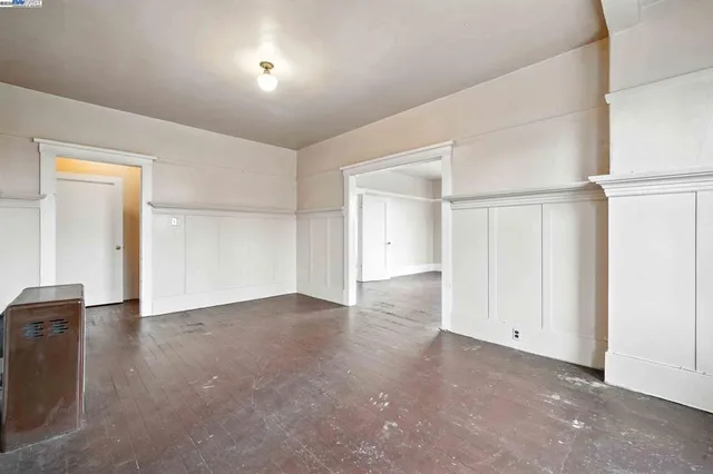 an empty room with closet and windows
