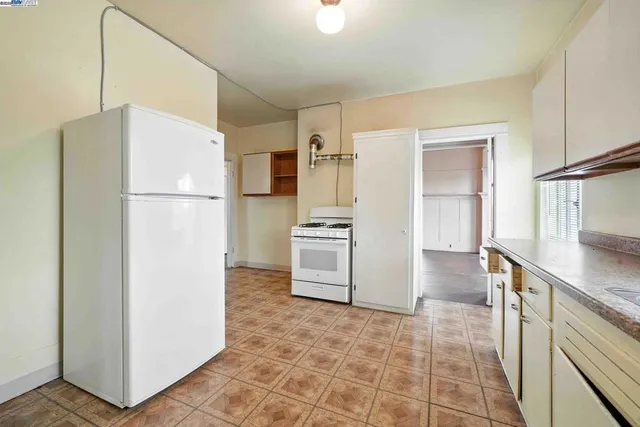 a kitchen with a refrigerator sink stove and cabinets