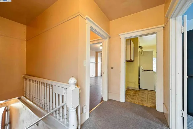 a view of a hallway with wooden floor and entryway
