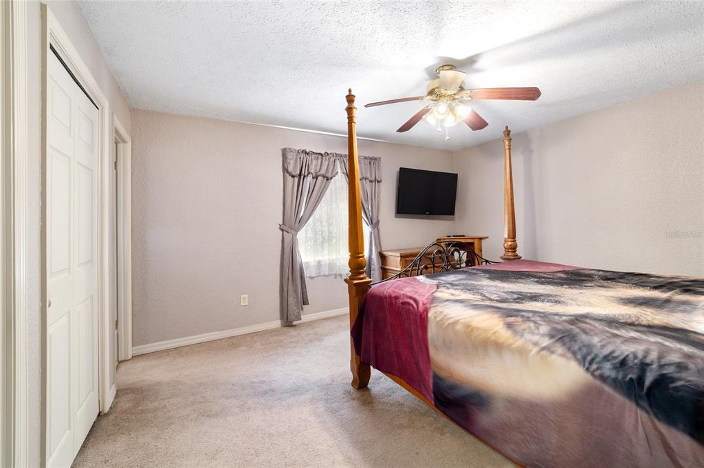 15755 Southwest 90th Avenue Dunnellon, FL 34432 - Photo 28 of 55 a bedroom with a bed and a flat screen tv