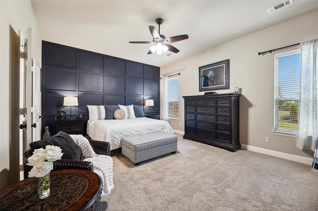 112 Shepherds Hill Road Waxahachie, TX 75165 - Photo 14 of 38 a spacious bedroom with a bed and a chandelier