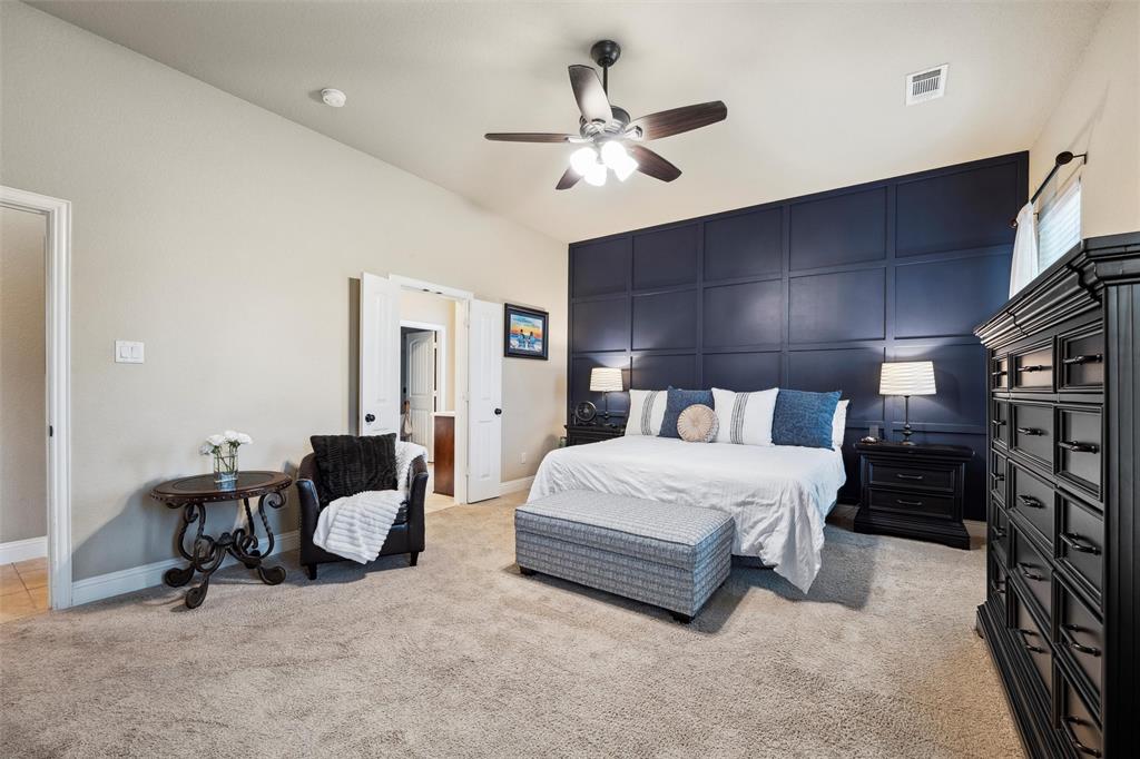 112 Shepherds Hill Road Waxahachie, TX 75165 - Photo 15 of 38 a spacious bedroom with a bed and a chandelier