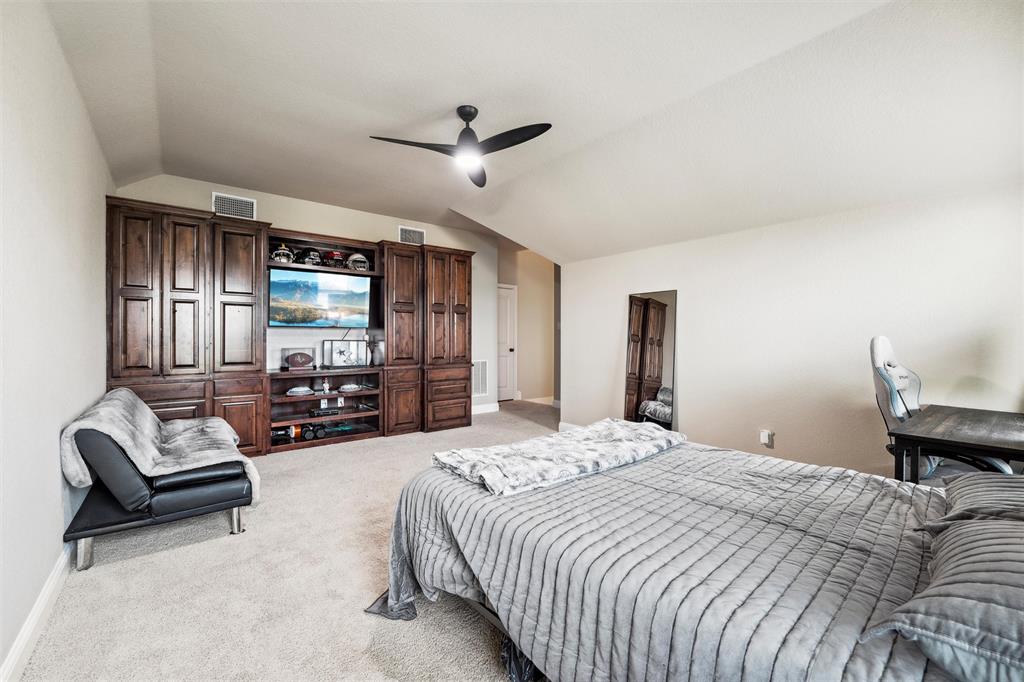 112 Shepherds Hill Road Waxahachie, TX 75165 - Photo 25 of 38 a bedroom with bed couches and flat tv screen