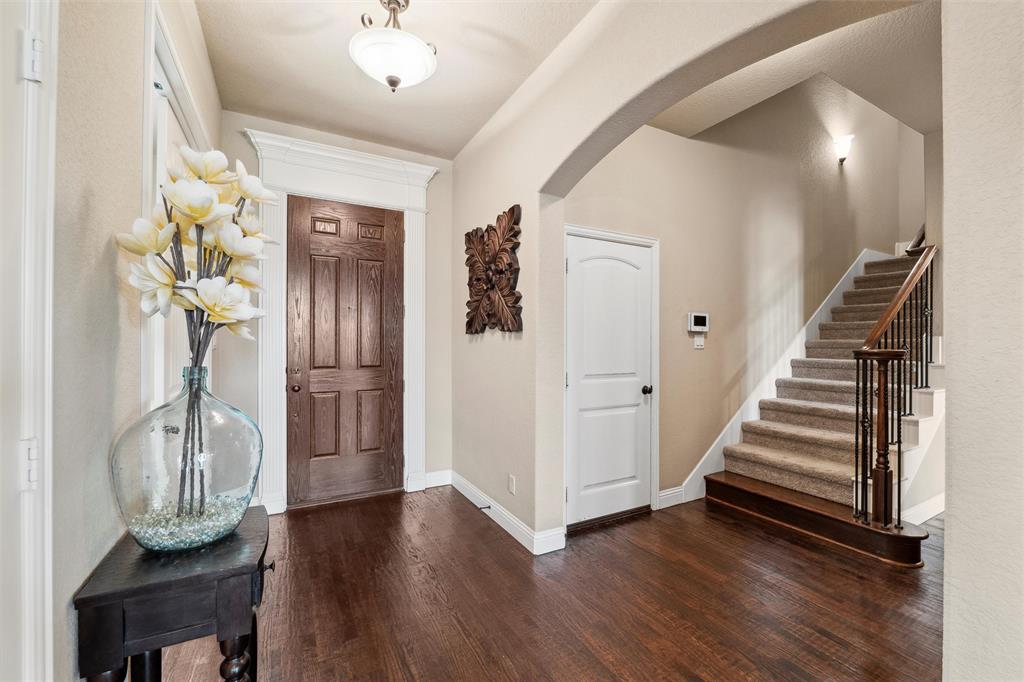 112 Shepherds Hill Road Waxahachie, TX 75165 - Photo 4 of 38 a view of a hallway with wooden floor and staircase