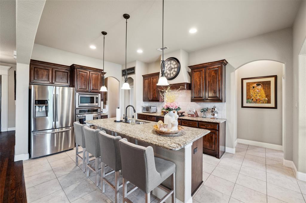 112 Shepherds Hill Road Waxahachie, TX 75165 - Photo 9 of 38 a kitchen with stainless steel appliances granite countertop a sink a stove and a refrigerator