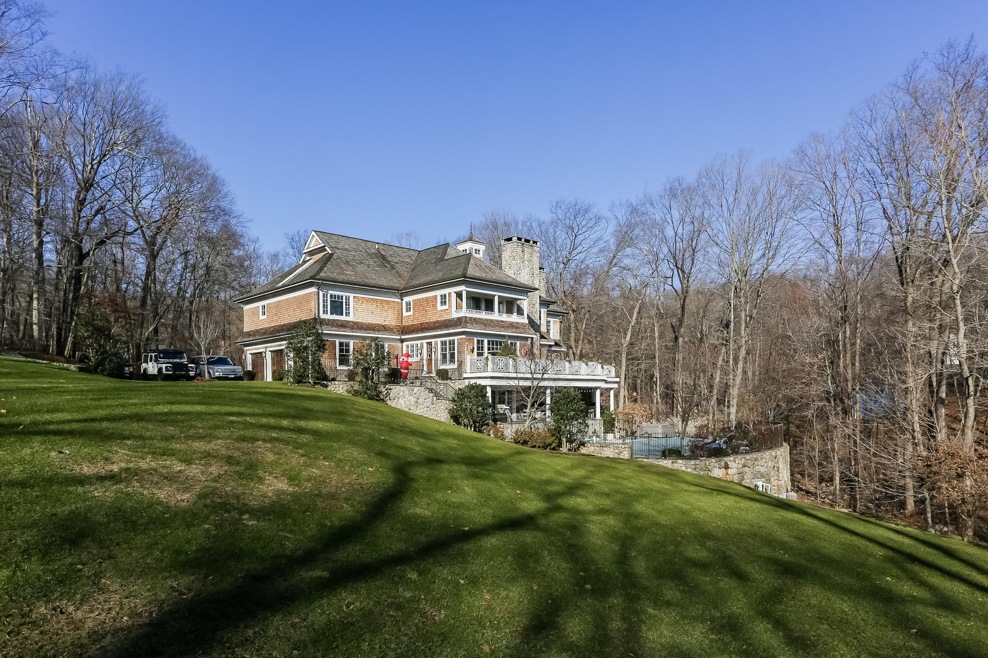 131 Thayer Pond Road New Canaan, CT 06840 - Photo 16 of 21 a white house with a big yard and large trees