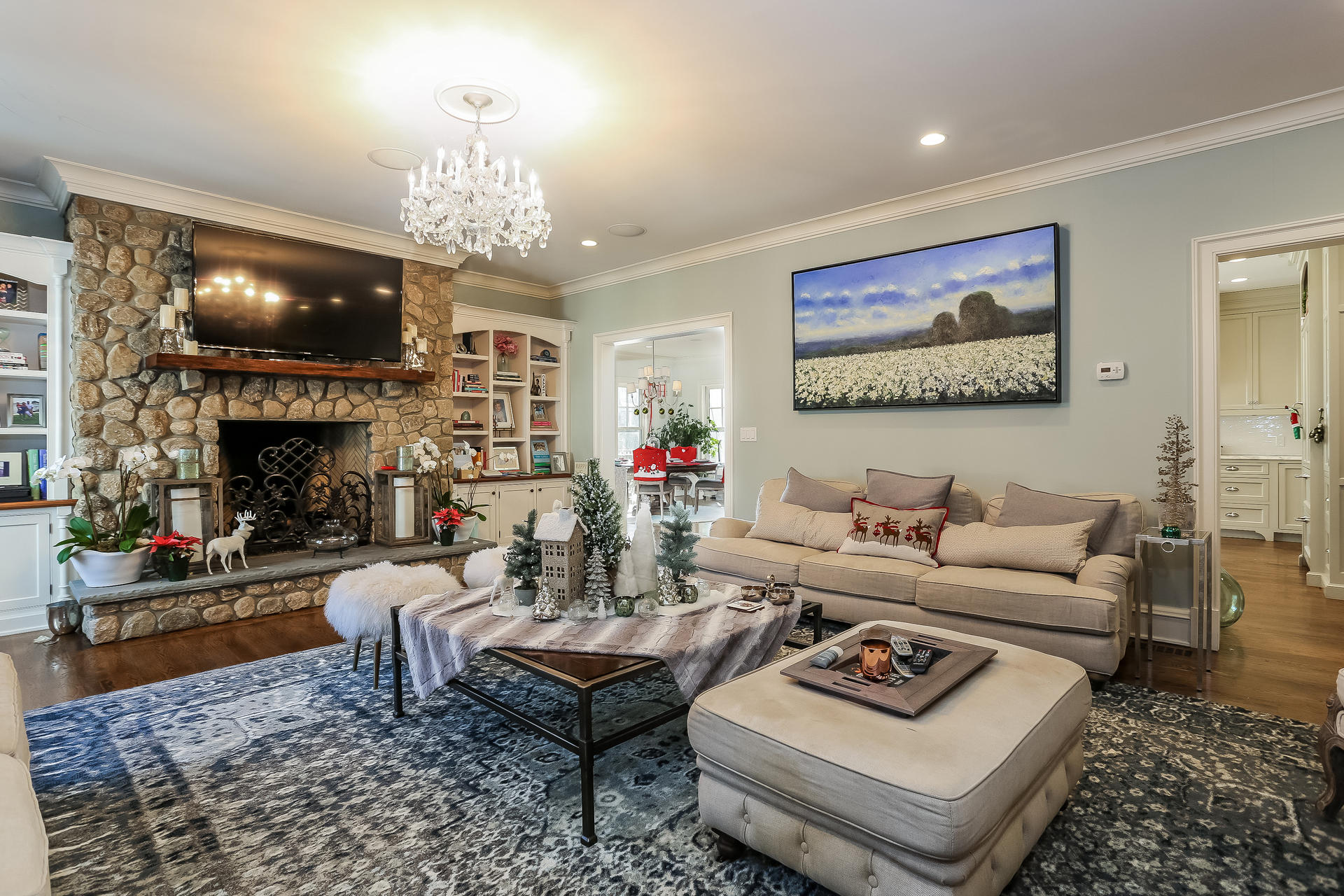 131 Thayer Pond Road New Canaan, CT 06840 - Photo 7 of 21 a living room with furniture a chandelier and a fireplace