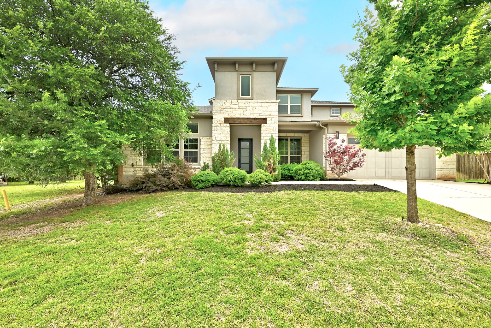 9008 Harper Rae Drive Austin, TX 78717 - Photo 1 of 39 Contemporary exterior with stone and stucco finishes