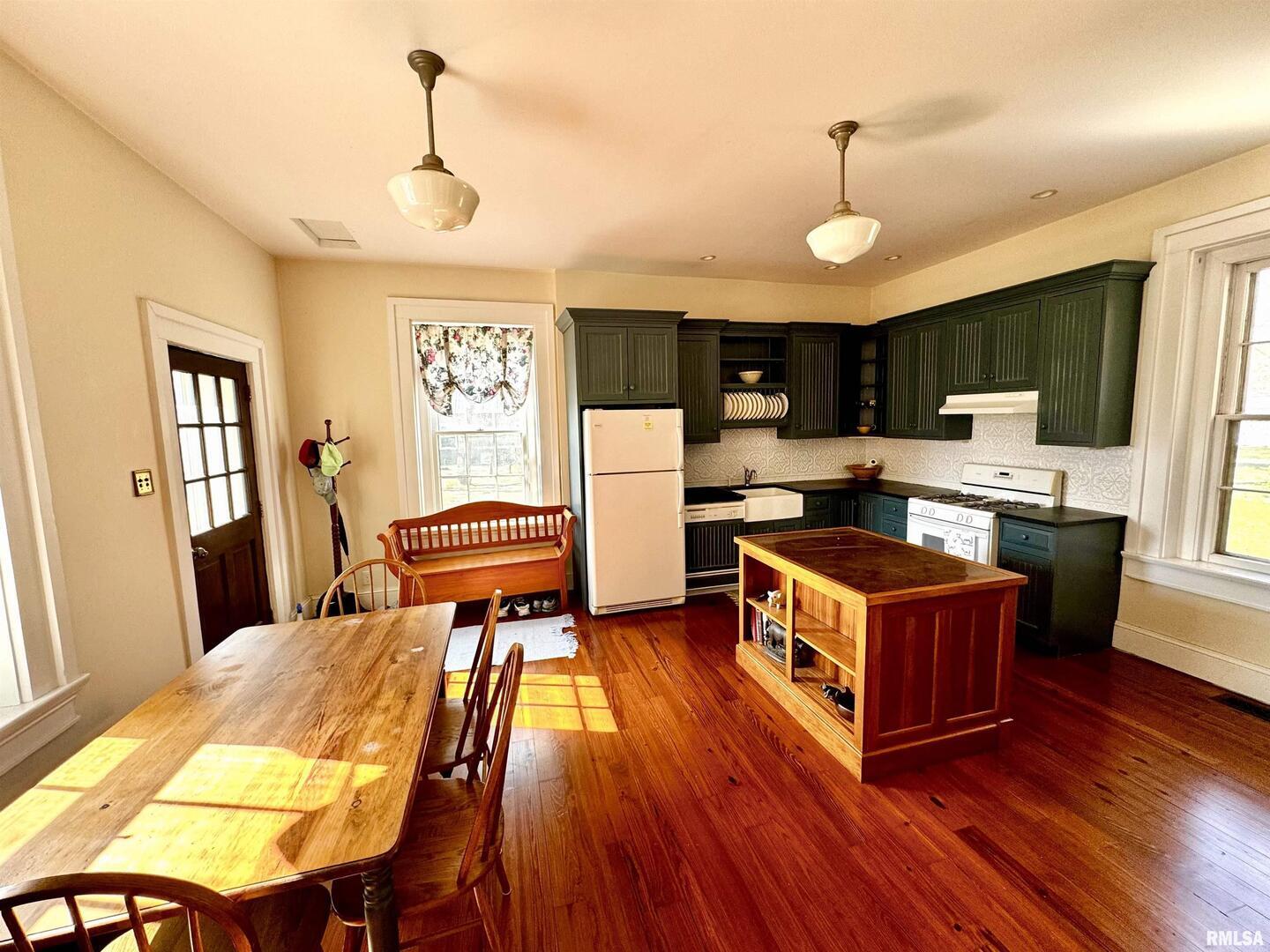 110 East Jefferson Street New Boston, IL 61272 - Photo 13 of 23 a kitchen with stainless steel appliances granite countertop wooden floors a stove a sink and a refrigerator