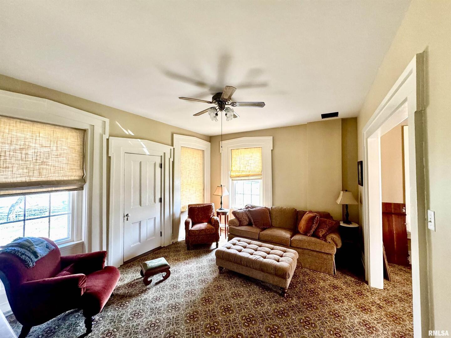 110 East Jefferson Street New Boston, IL 61272 - Photo 14 of 23 a living room with furniture gym equipment and a window