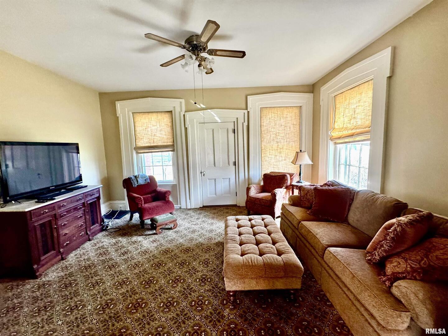 110 East Jefferson Street New Boston, IL 61272 - Photo 15 of 23 a living room with furniture ceiling fan and a window