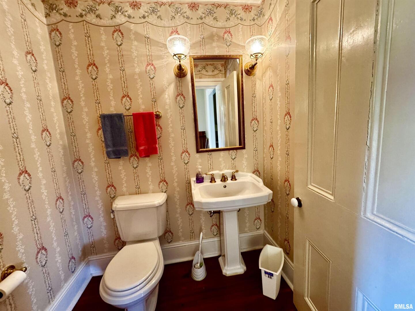 110 East Jefferson Street New Boston, IL 61272 - Photo 16 of 23 a bathroom with a toilet sink and mirror