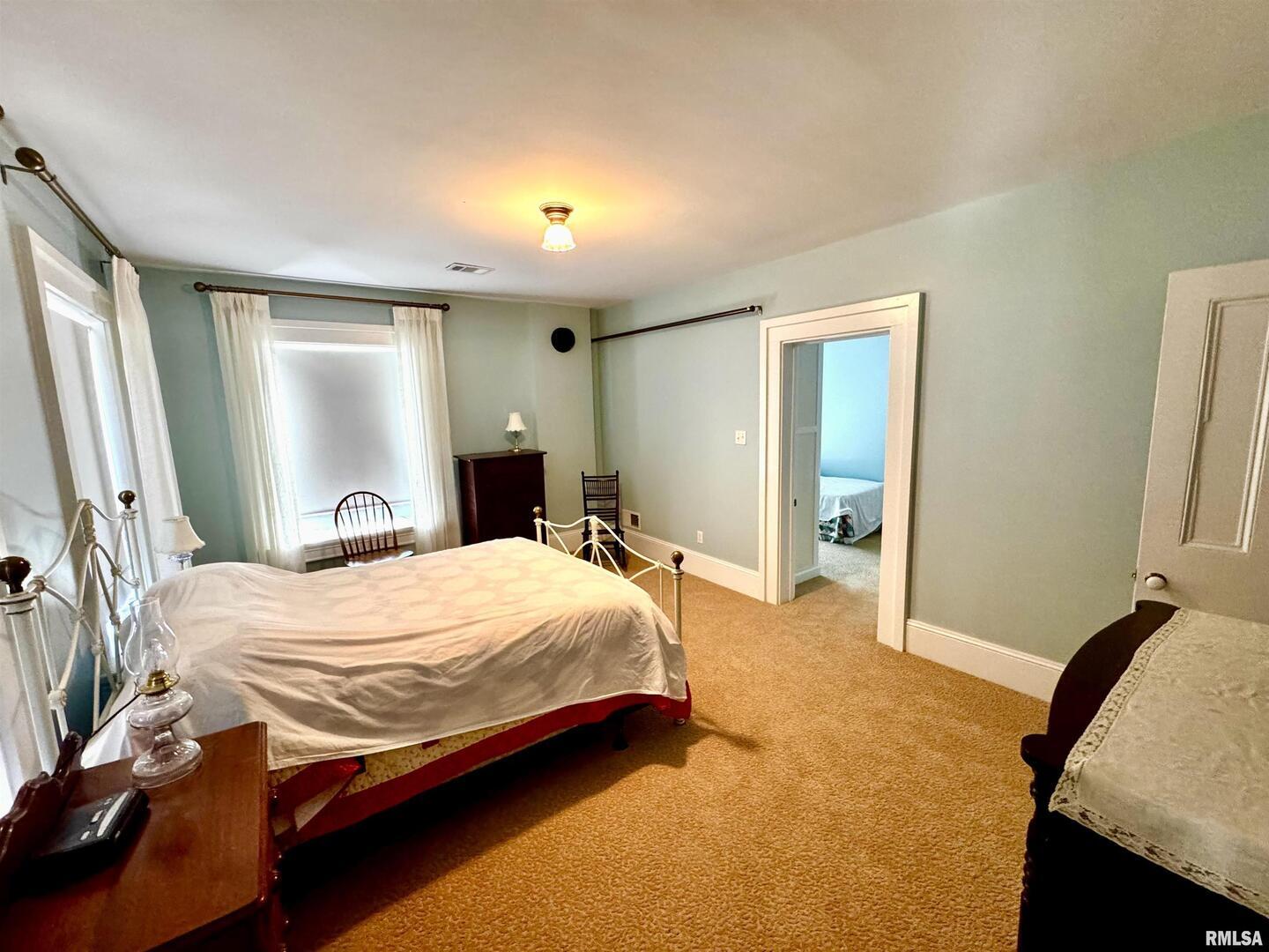 110 East Jefferson Street New Boston, IL 61272 - Photo 17 of 23 a bedroom with a bed and wooden floor