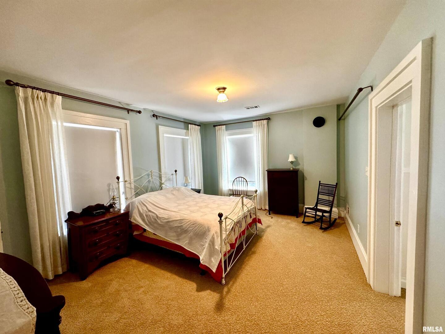 110 East Jefferson Street New Boston, IL 61272 - Photo 18 of 23 a bedroom with a bed and wooden floor