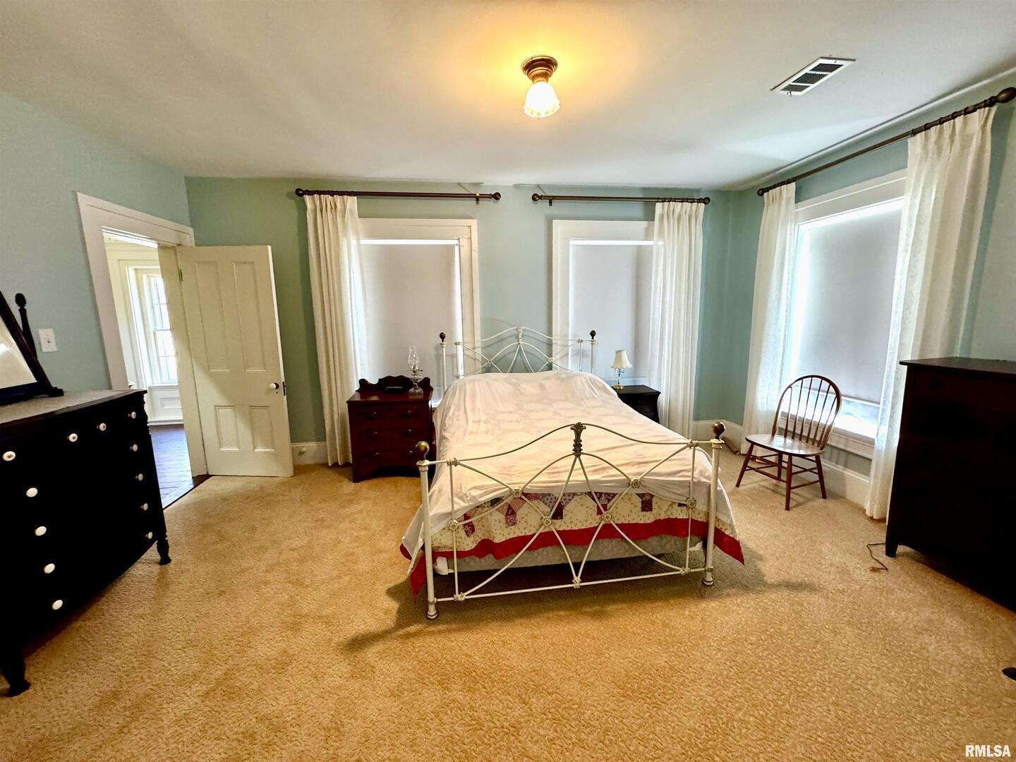 110 East Jefferson Street New Boston, IL 61272 - Photo 19 of 23 a bedroom with a bed and wooden floor