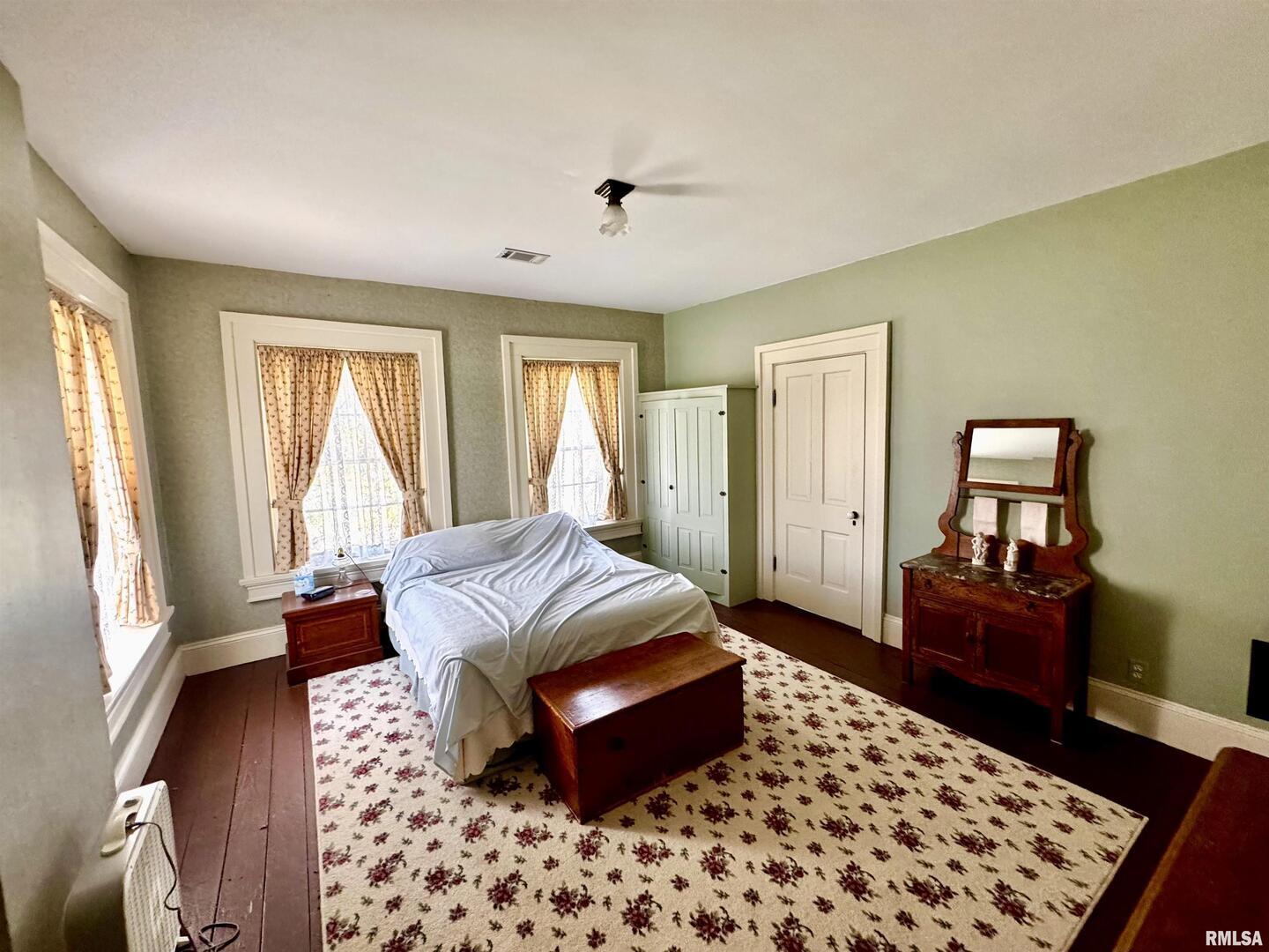 110 East Jefferson Street New Boston, IL 61272 - Photo 22 of 23 a bedroom with a bed and wooden floor