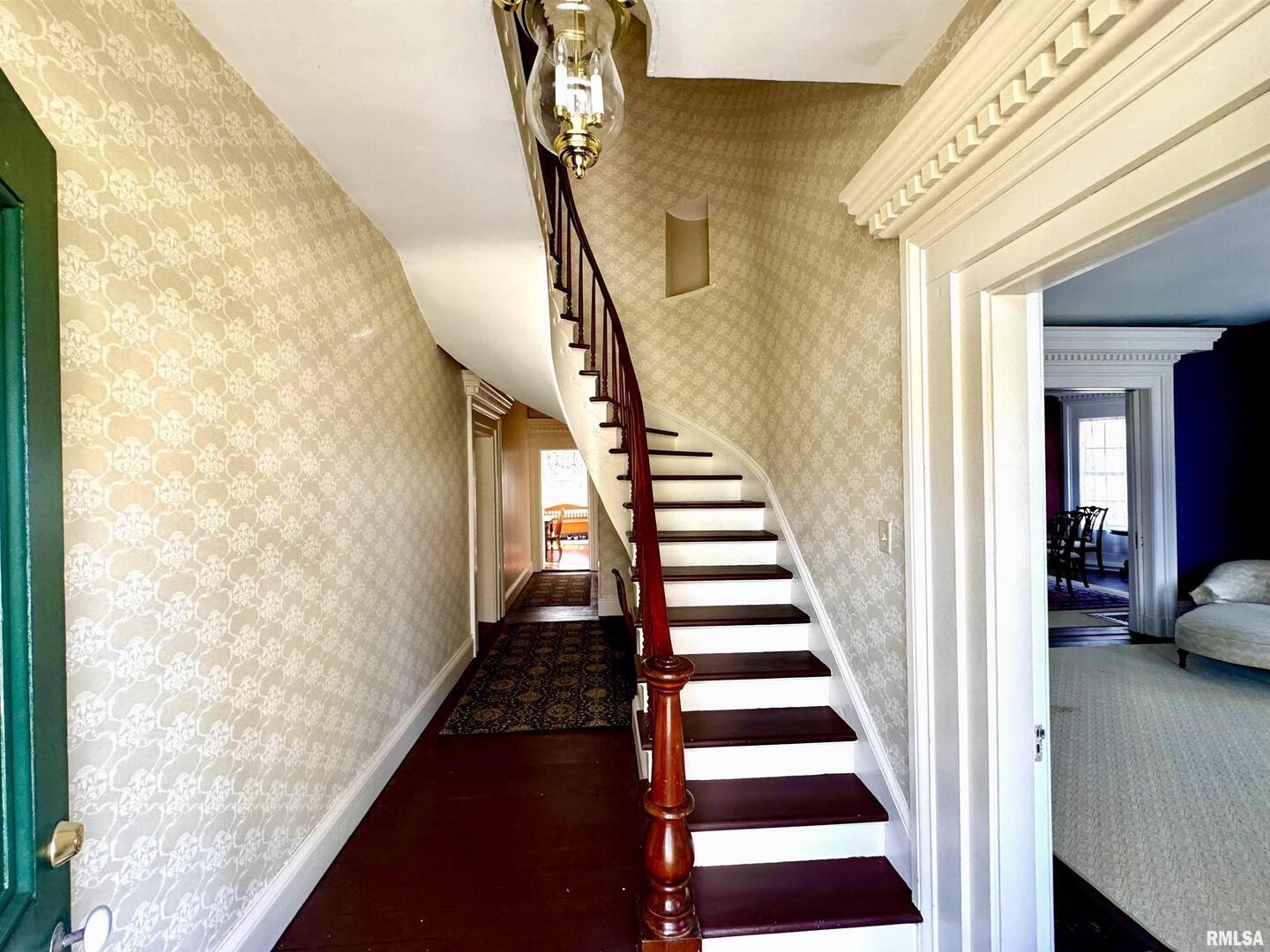 110 East Jefferson Street New Boston, IL 61272 - Photo 8 of 23 a view of a hallway with wooden floor and staircase