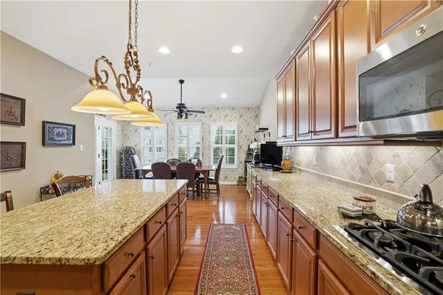 a kitchen with stainless steel appliances granite countertop a sink stove and refrigerator