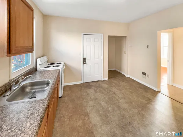 a kitchen with a sink stove and refrigerator