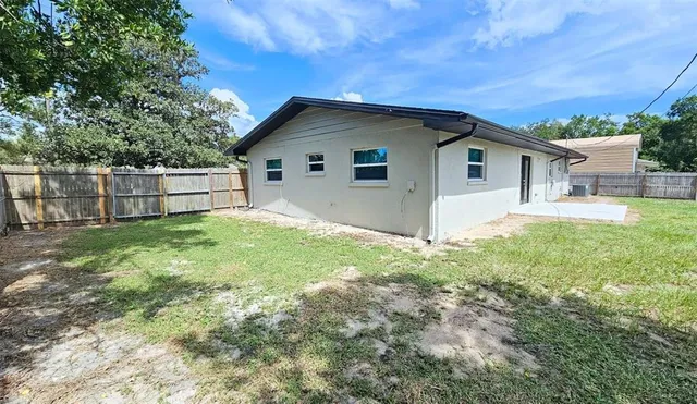 a view of a house with yard and a garden
