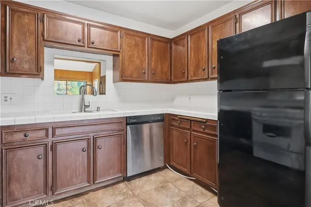 a kitchen with granite countertop a sink stove and cabinets