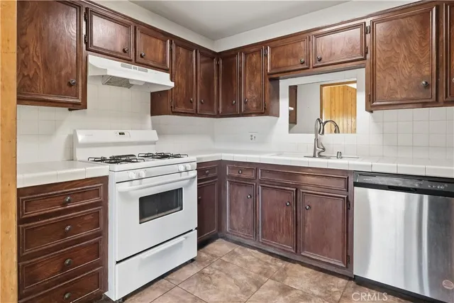 a view of a hallway with wooden floor and entryway