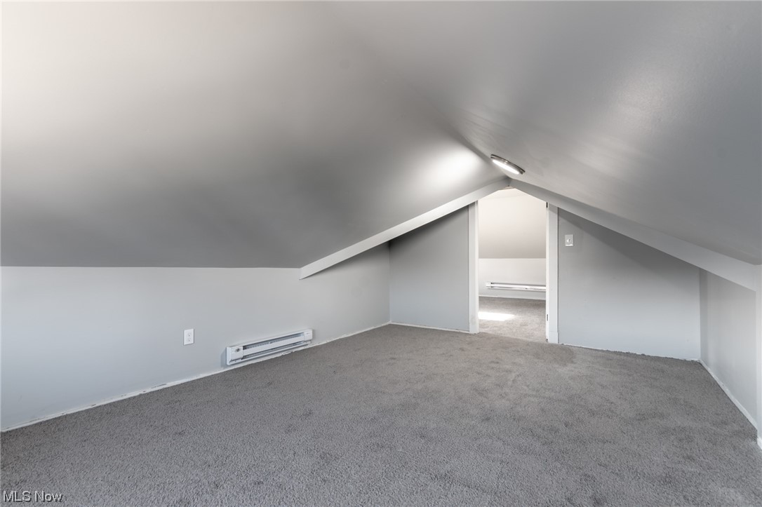 1228 Melbourne Road Cleveland, OH 44112 - Photo 27 of 35 Bonus room featuring lofted ceiling, carpet floors, and a baseboard radiator