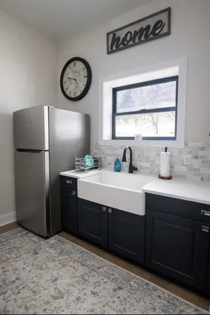 a kitchen with a refrigerator and a sink