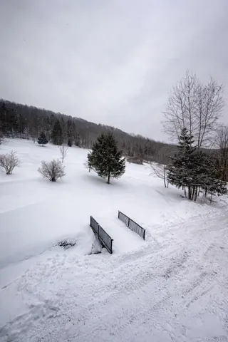 a view of terrace with lawn chairs and mountain view