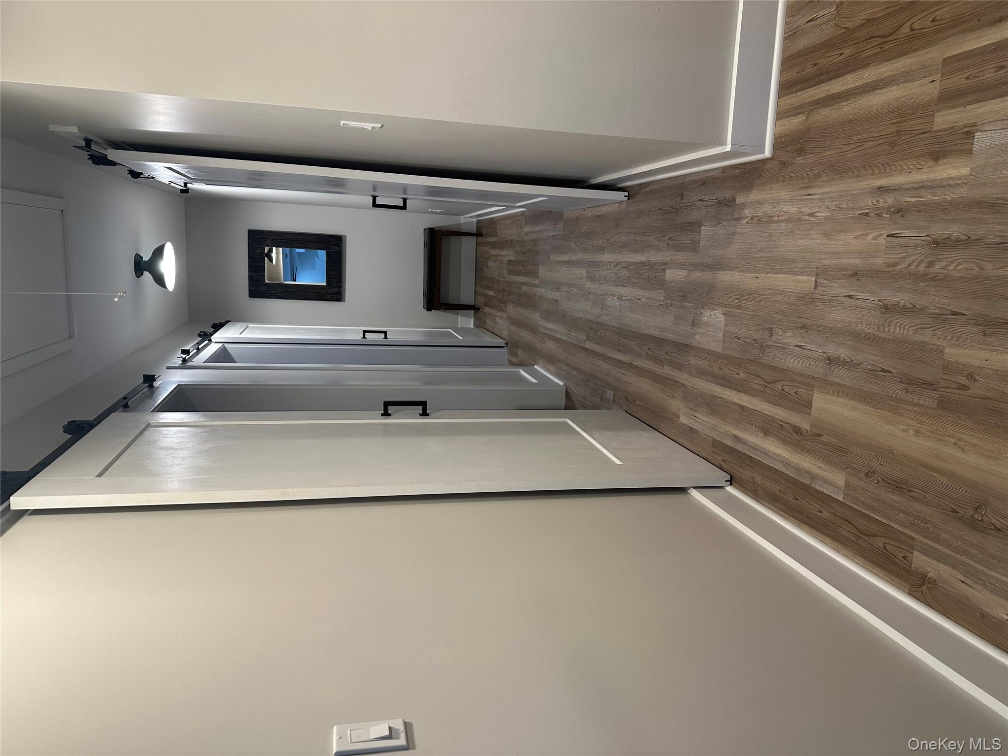 161 Hazel Road Livingston Manor, NY 12758 - Photo 15 of 24 Corridor featuring a barn door, wood finished floors, and attic access