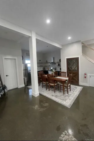 a living room with furniture and a piano