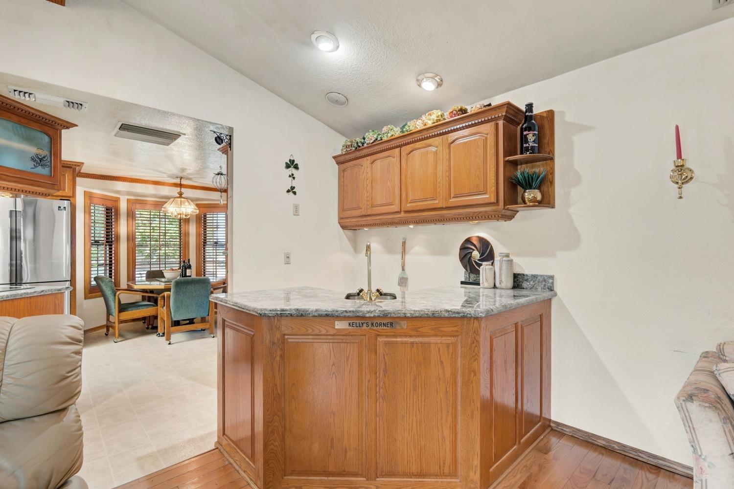 2952 Royce Drive Rescue, CA 95672 - Photo 16 of 70 Wet bar with wood cabinetry, and light-toned granite countertop.