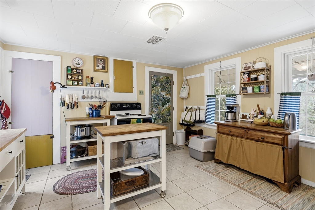 118 North Leverett Road Leverett, MA 01054 - Photo 8 of 26 a kitchen with a stove a refrigerator and a dining table