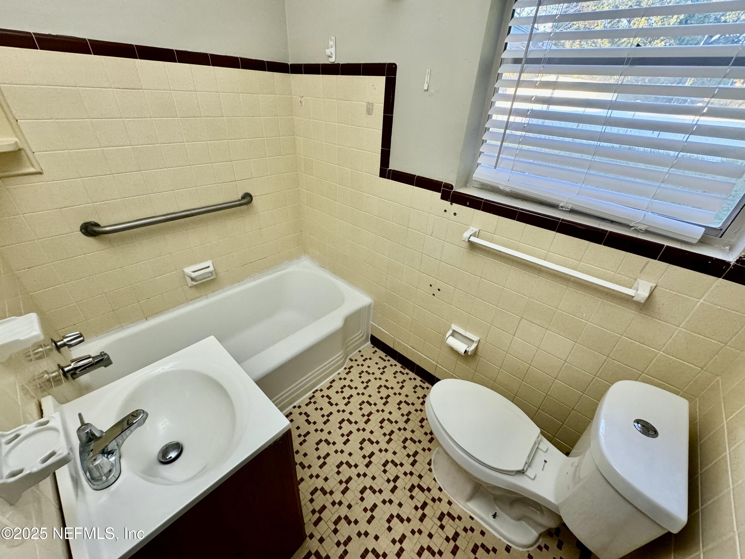 1157 Gunka Road Jacksonville, FL 32216 - Photo 19 of 24 a bathroom with a sink and a mirror