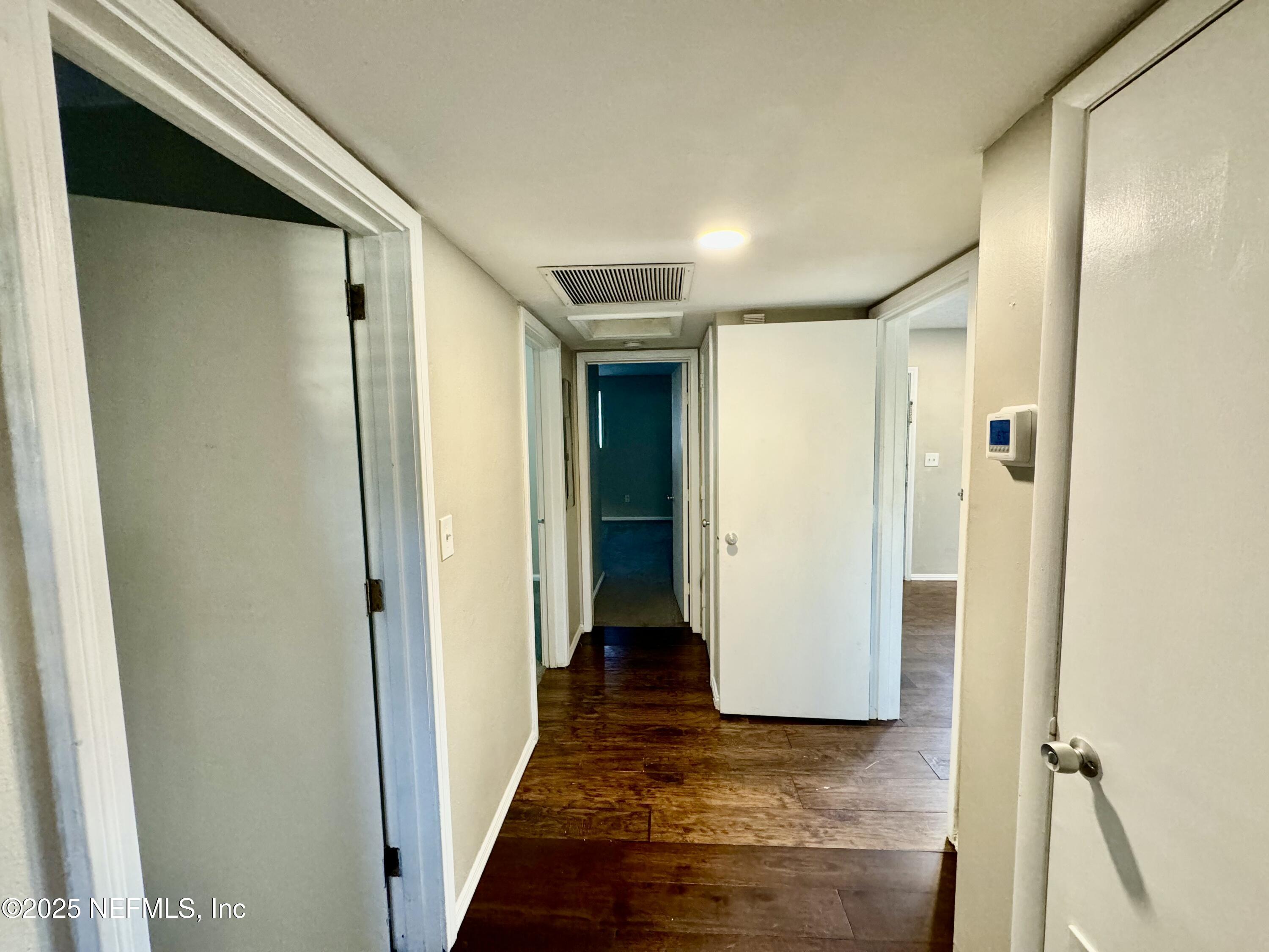 1157 Gunka Road Jacksonville, FL 32216 - Photo 20 of 24 a view of a hallway with wooden floor and closet