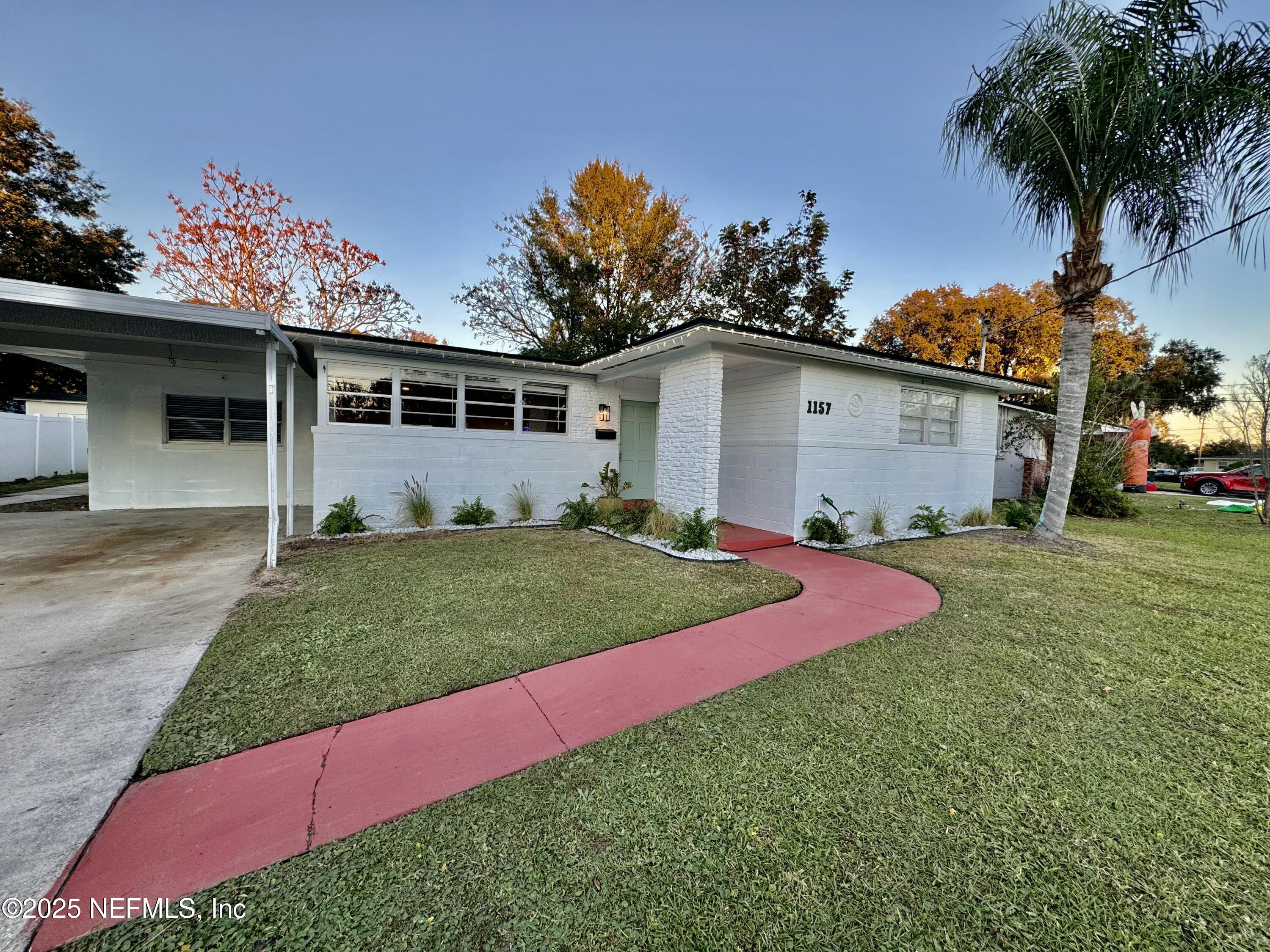 1157 Gunka Road Jacksonville, FL 32216 - Photo 2 of 24 a view of a yard with a house and garden