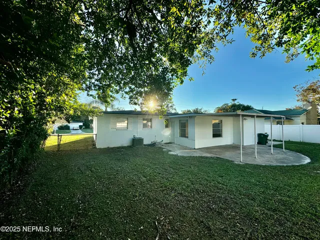 a view of a house with a yard garage and sitting area