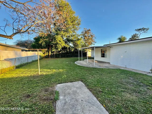 a backyard of a house with lots of green space
