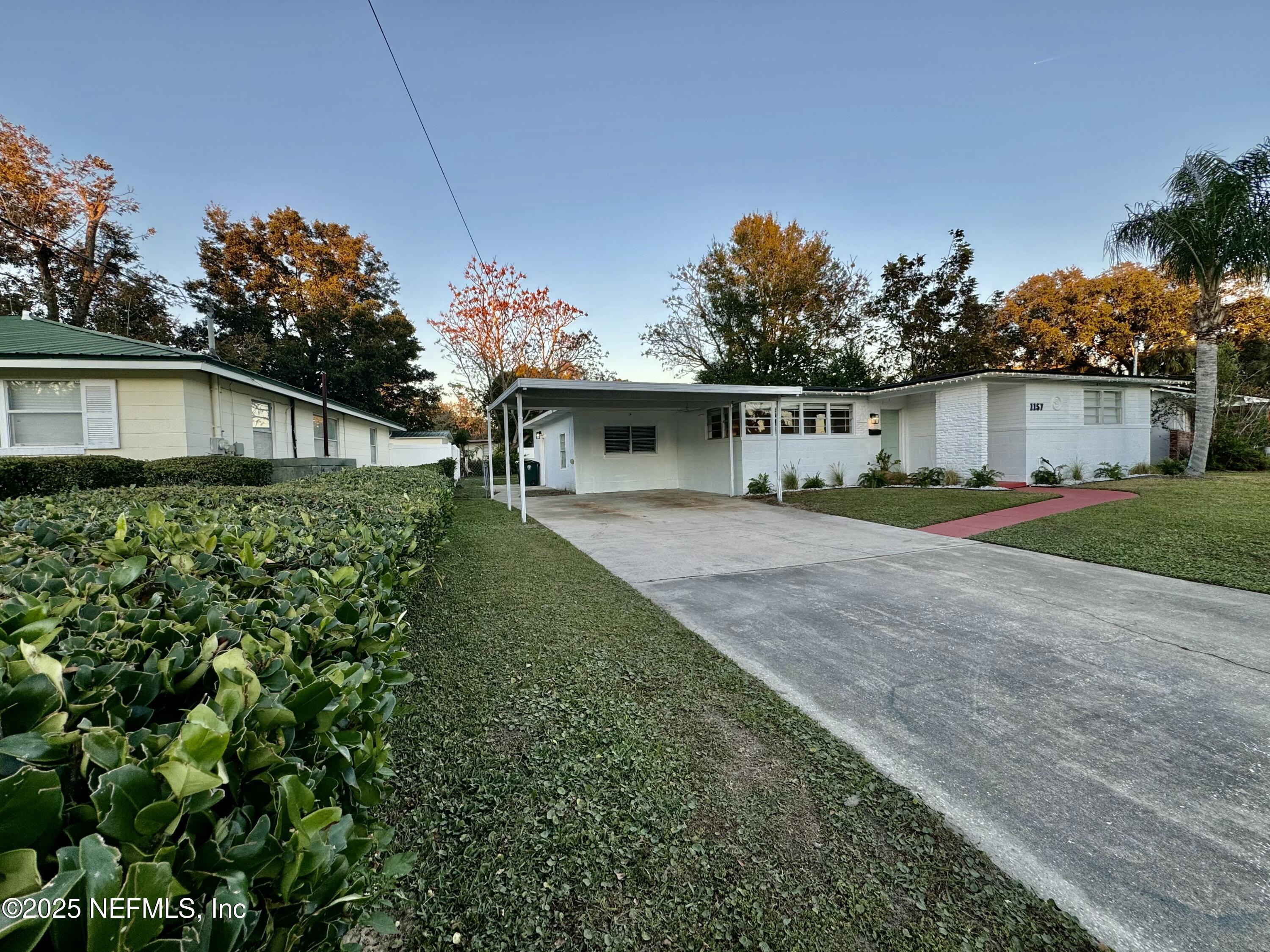 1157 Gunka Road Jacksonville, FL 32216 - Photo 24 of 24 a front view of a house with a yard and trees