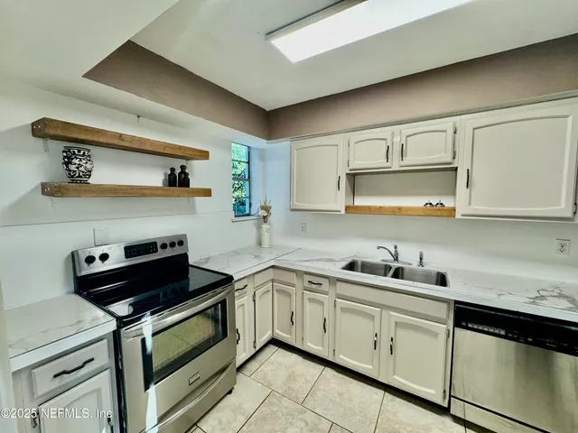a kitchen with cabinets a sink and appliances
