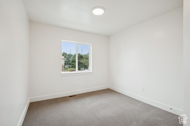 1615 North Angel Street, Unit H Layton, UT 84041 - Photo 22 of 55 Carpeted spare room featuring baseboards
