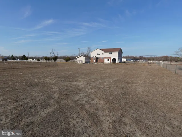 a view of a big room with an ocean and trees