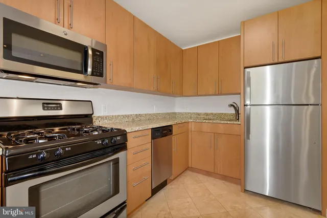 a kitchen with a refrigerator stove and microwave